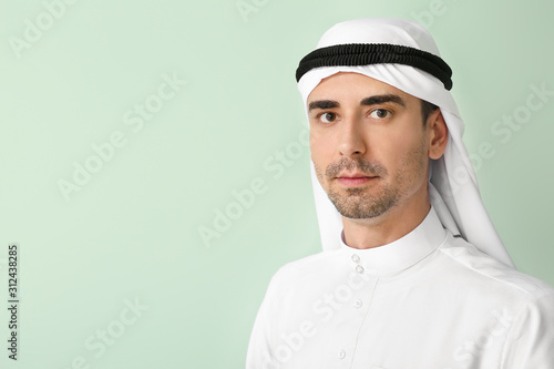 Handsome Arab man on color background