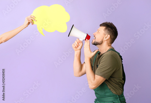 Worker with megaphone and b...
