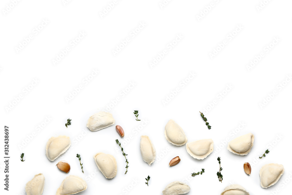 Raw dumplings with spices on white background
