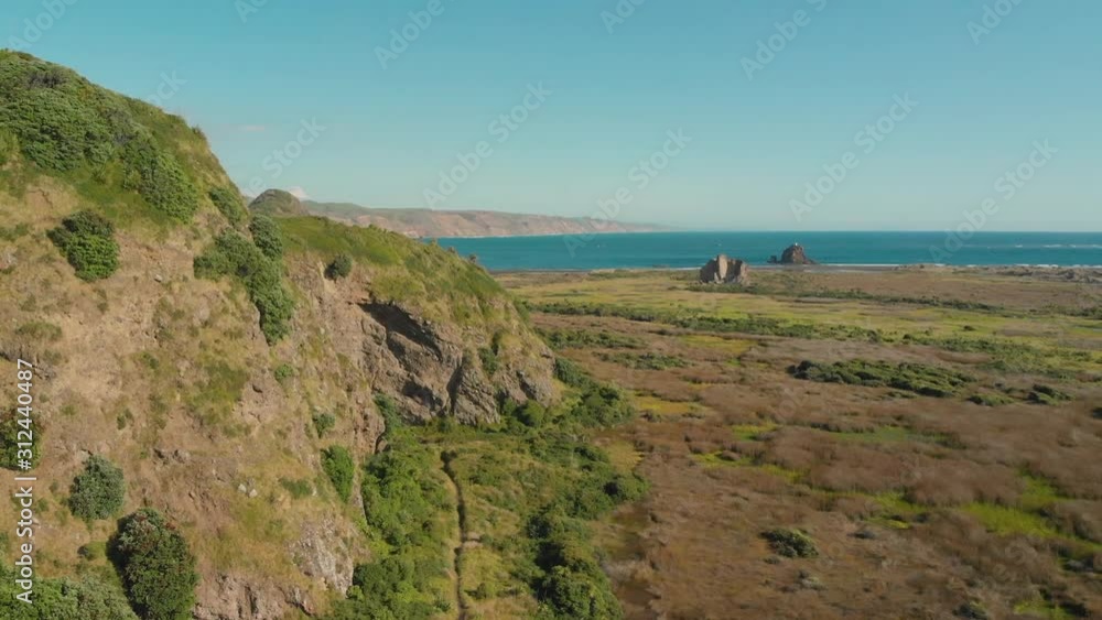 Flying over New Zealand coastal rocky scenery towards black sand vulanic Whatipu Beach Flying over New Zealand coastal rocky scenery towards black sand vulanic Whatipu Beach