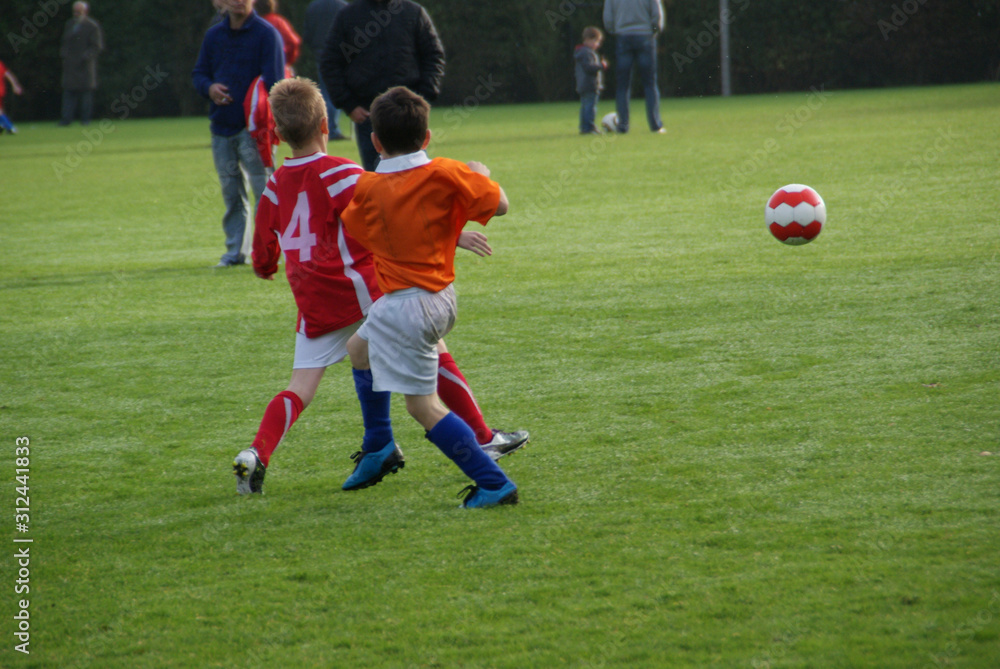 Obraz premium young boys soccer players game in action kicking ball