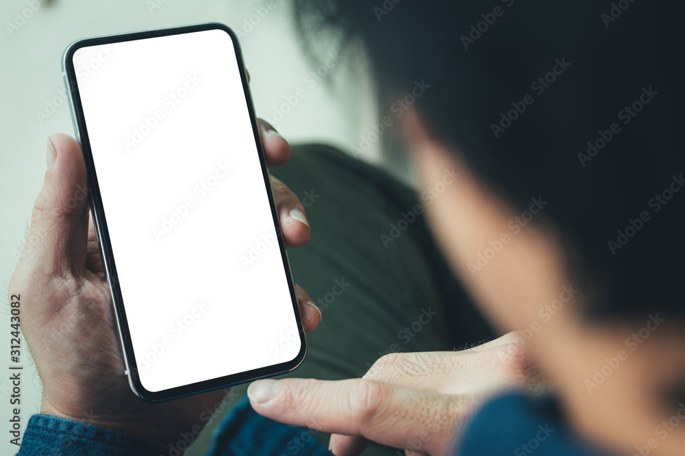 Mockup image blank white screen cell phone.man hand holding texting using mobile on sofa at coffee shop.background empty space for advertise text.people contact marketing business,technology Mockup image blank white screen cell phone.man hand holding texting using mobile on sofa at coffee shop.background empty space for advertise text.people contact marketing business,technology