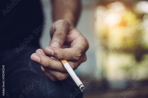 selective focus young man smoking cigarette.concept for breaking and quite cigarette for healthy.background empty space for text.