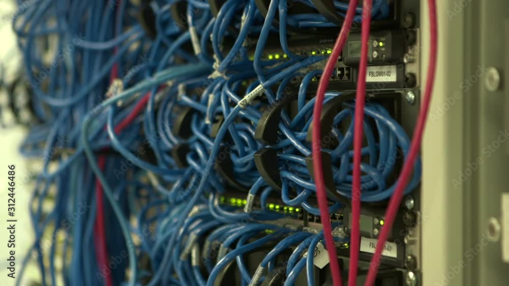 Network cables strung messy connecting different ports of patch panel routers Network cables strung messy connecting different ports of patch panel routers