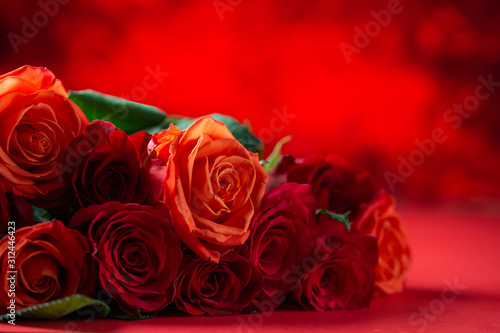 Festive bouquet with red roses on a colored background  congratulations on February 14  Valentine s Day. Love and romance