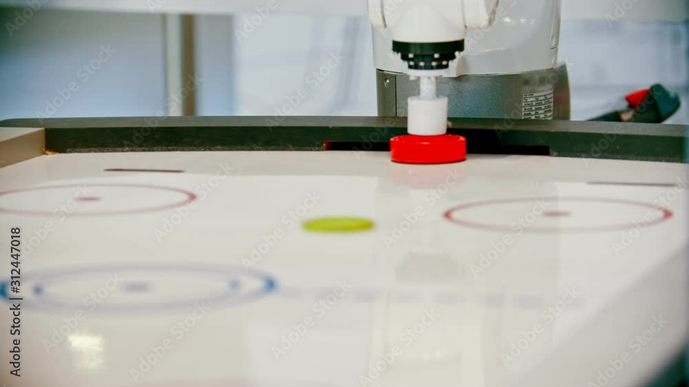 Two robotic machines having an air hockey match with each other Two robotic machines having an air hockey match with each other