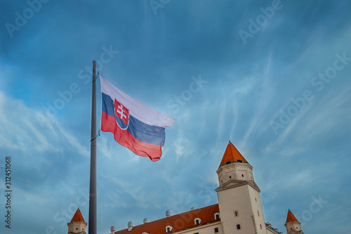 Photography Flag of Slovakia with fragments of Bratislava Castle against the sky