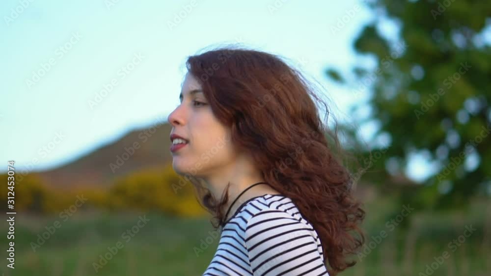 Side View Portrait of Attractive Late 20s Brown Hair Woman Wearing Striped Shirt Walking in Nature Outdoors Slow Motion Side View Portrait of Attractive Late 20s Brown Hair Woman Wearing Striped Shirt Walking in Nature Outdoors Slow Motion
