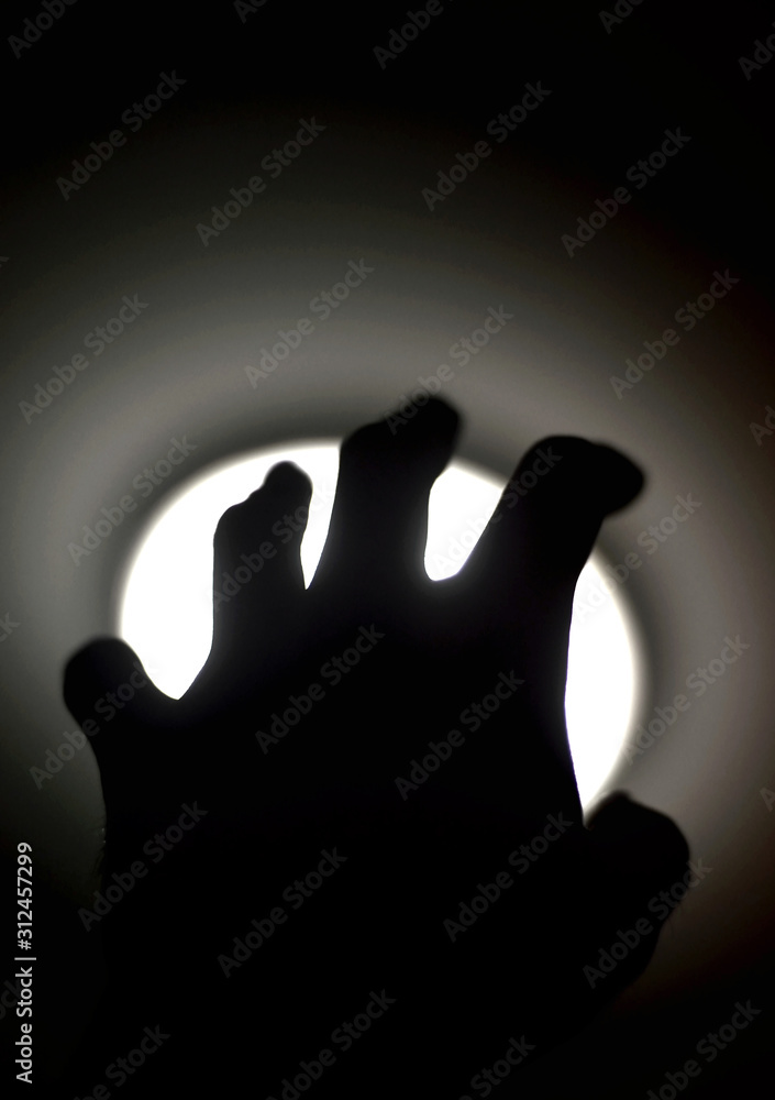 Silhouette of human hand reaching out to light, Need help concept