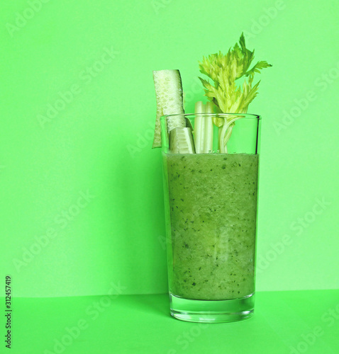 Fresh green smoothie from fruit and vegetables for a healthy lifestyle spinach, green Apple, cucumber, oatmeal isolated on bright marble background. Overhead view, copy space. Advertising for cafe