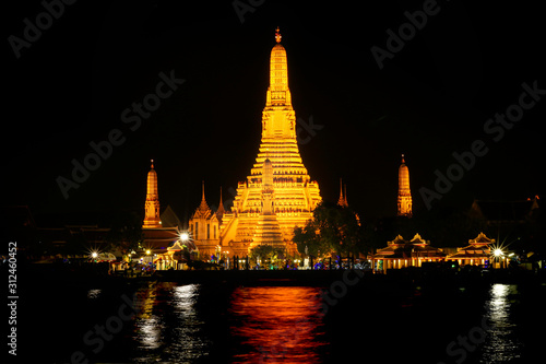 Beautiful view of Wat Arun Temple or Temple of the Dawn on the Chao Phraya river banks at night. The famous landmarks of Bangkok  Thailand.