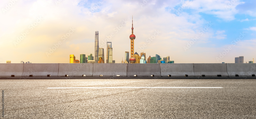 Panorama of empty asphalt road and city skyline landscape at sunset in Shanghai