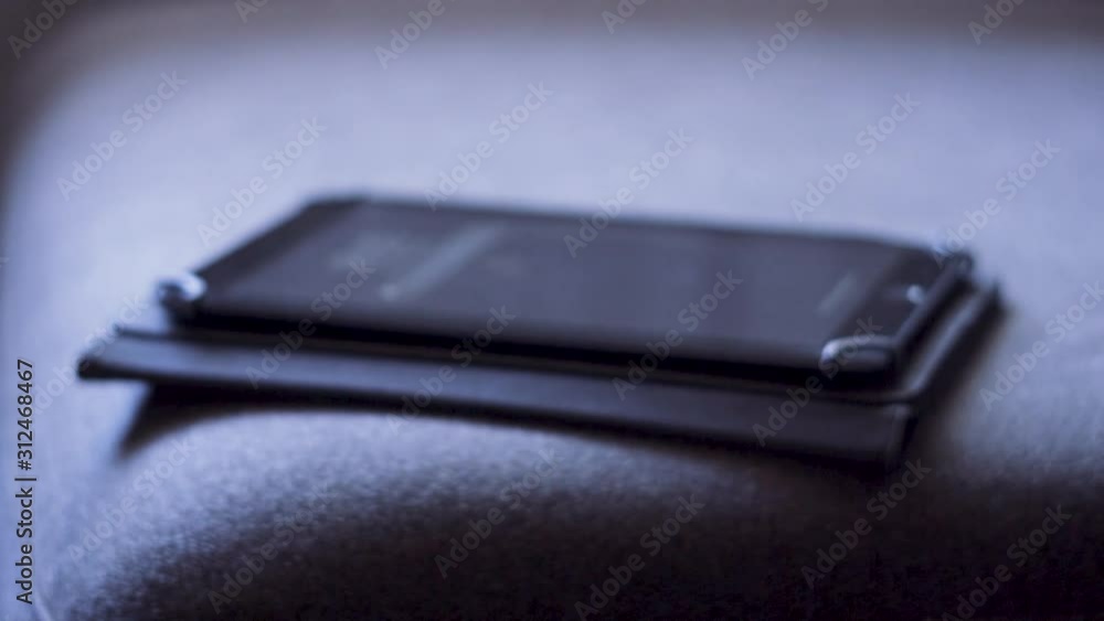 Shooted in slow motion showing man's hands browsing social media or playing with a mobile tablet at evening (dark space) Shooted in slow motion showing man's hands browsing social media or playing with a mobile tablet at evening (dark space)