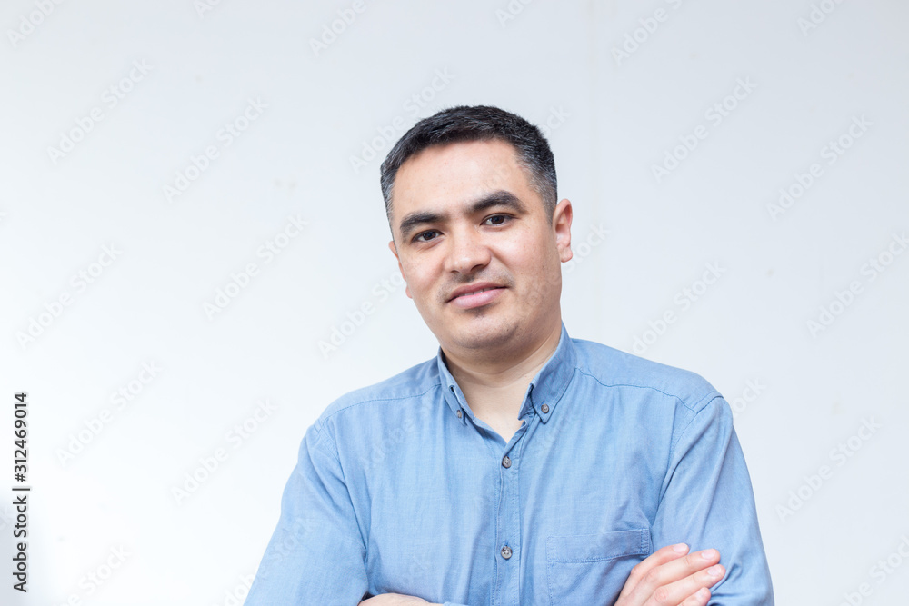 Attractive handsome smiling positive happy business man. Closeup portrait of a polite middle age man wearing a blue shirt Attractive handsome smiling positive happy business man. Closeup portrait of a polite middle age man wearing a blue shirt