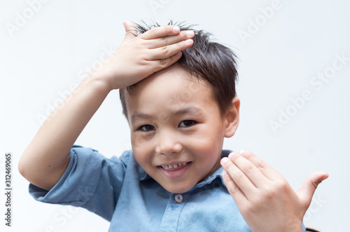 Portrait of a child in a blue shirt on a white background