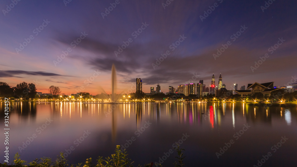 Kuala Lumpur city waterfront skyline with reflections and beautiful morning sky