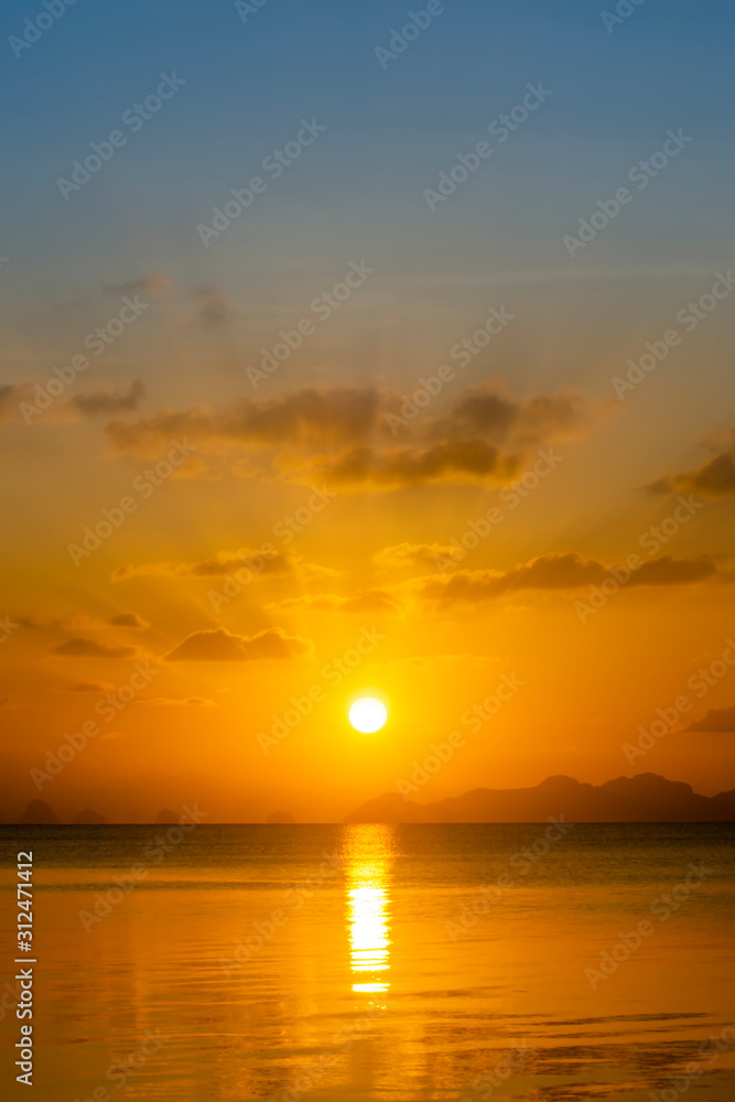 Vertical image of Sunset sky at the lake with clouds.