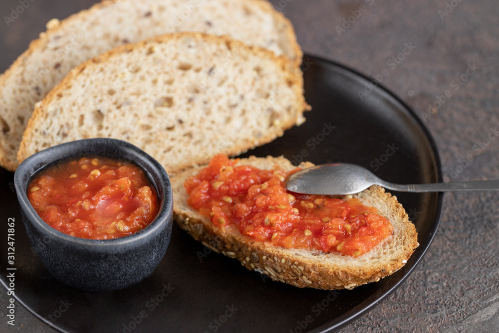 Pa amb tomaquet or tomaca (bread with tomato) classic snack in Catalanonia and Spanish cuisine, eaten for breakfast. Pa amb tomaquet or tomaca (bread with tomato) classic snack in Catalanonia and Spanish cuisine, eaten for breakfast.