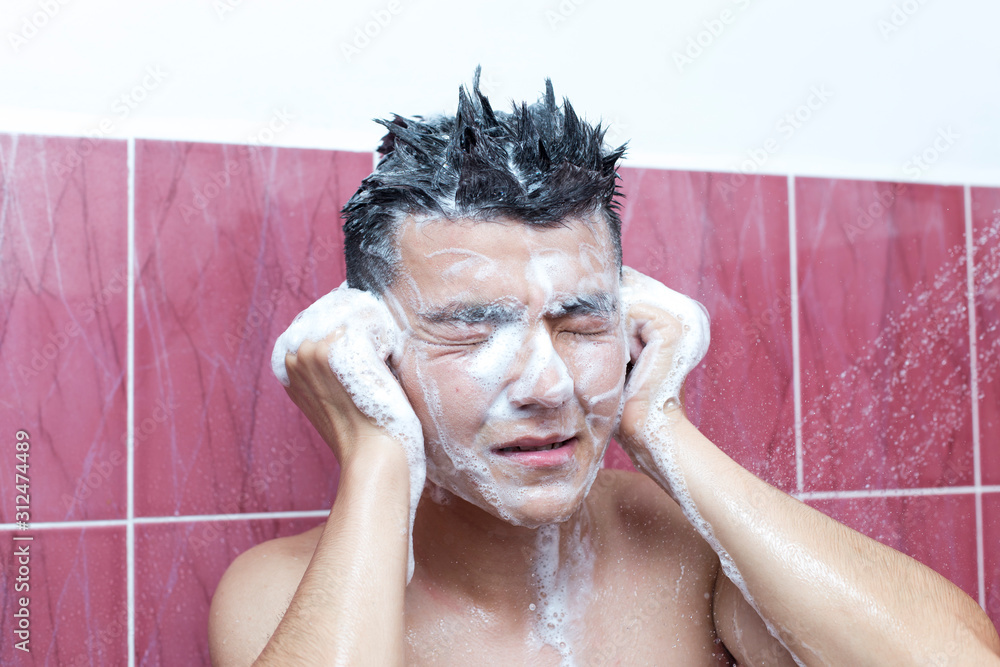 Asian handsome young man bathing in bathroom Asian handsome young man bathing in bathroom