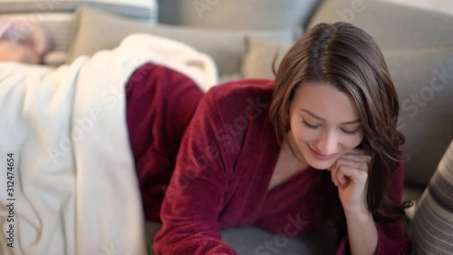 Pretty Woman Smiles Writing in her Journal in her Pajamas photo