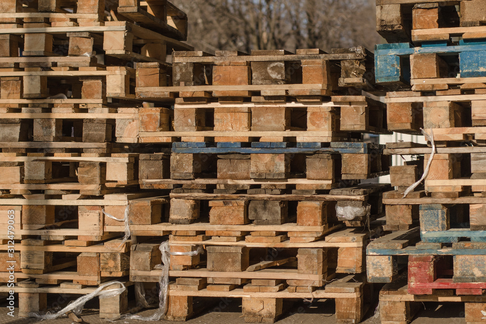 Stacks of wooden pallets. Cargo pallets. Pile of used wooden cargo shipping pallets. Stacks of wooden pallets. Cargo pallets. Pile of used wooden cargo shipping pallets.