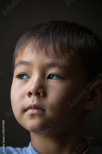 portrait of a child at home by the window