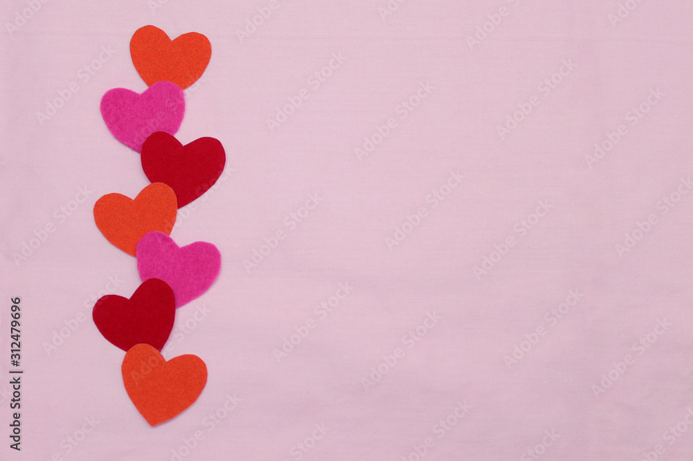 A row of red, pink, ornamental hearts on a pink background. empty space in the center for text and copy. Valentine's day stock photos