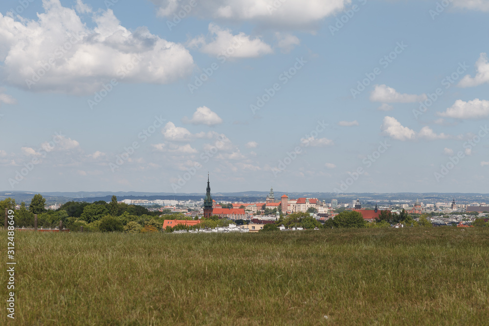 Fototapeta premium Panoramic view of Old City in Cracow at the noon. The view from the hill of Krakus Mound
