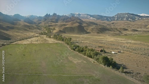 Aerial flying over a ranch and mountains in the countryside. Cody, Wyoming, USA