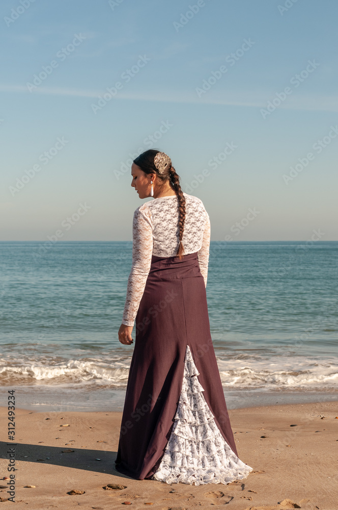 Young Spanish woman dancing flamenco on the beach Young Spanish woman dancing flamenco on the beach
