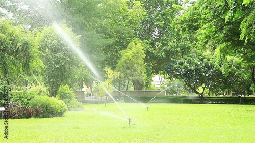 High power lawn sprinkler watering grass in garden