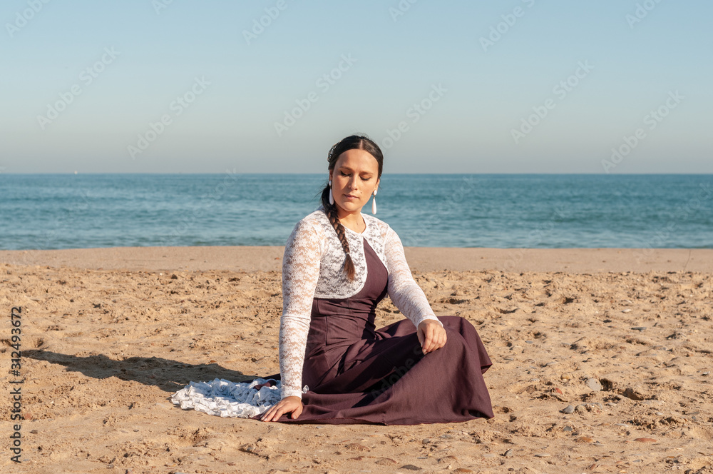 Young Spanish woman dancing flamenco on the beach Young Spanish woman dancing flamenco on the beach