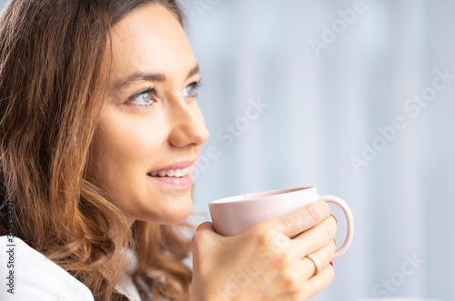Young woman drinking a cup of coffee.