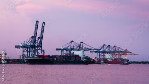 Cargo ship loading goods at shipping port