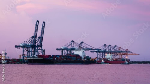 Cargo ship loading goods at shipping port