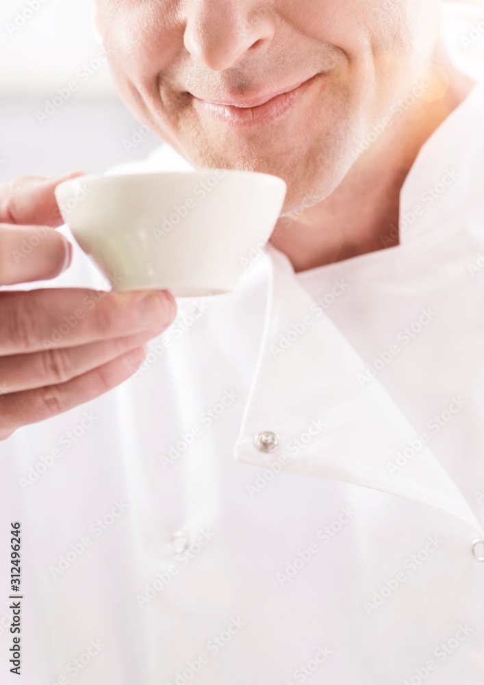 Closeup of confident mature chef smelling food in bowl at restaurant Closeup of confident mature chef smelling food in bowl at restaurant