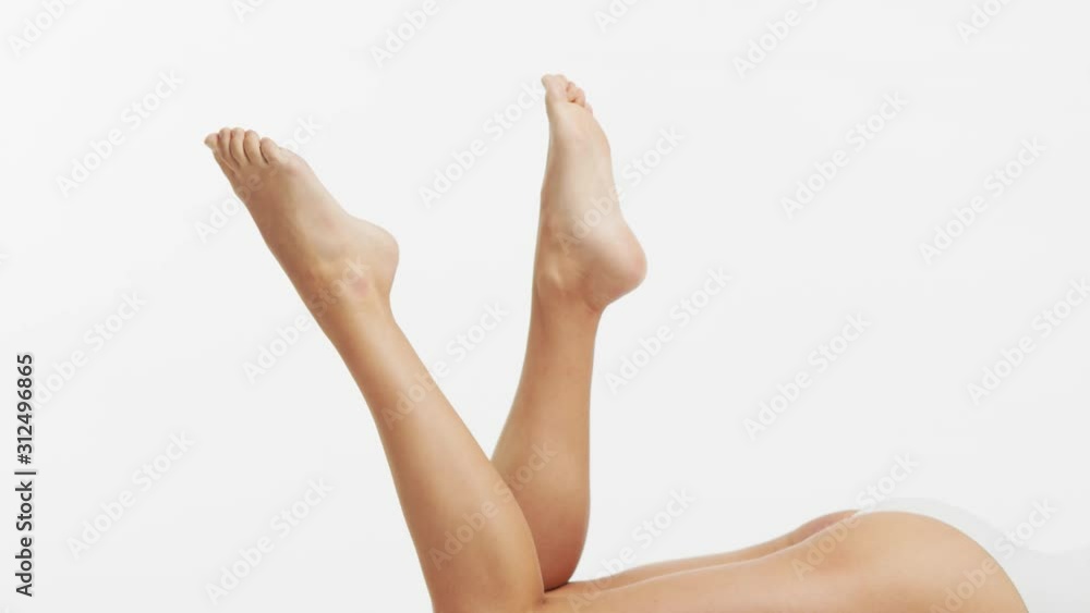 Young, beautiful, slim and healthy girl in white swimsuit applying skincare cream. Massage, skincare, healthcare, wrinkles removal and fitness. Young, beautiful, slim and healthy girl in white swimsuit applying skincare cream. Massage, skincare, healthcare, wrinkles removal and fitness.