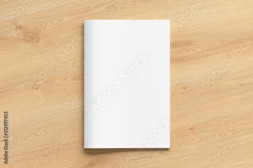 Brochure or booklet cover mock up on wooden background. Isolated with clipping path around brochure. View above. 3d illustratuion