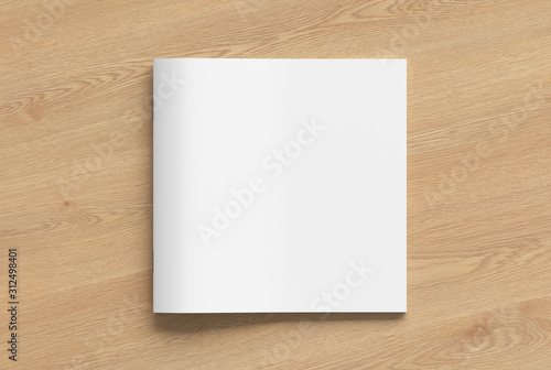 Blank square brochure or booklet cover mock up on wooden background. Isolated with clipping path around brochure. View above.  3d illustratuion photo