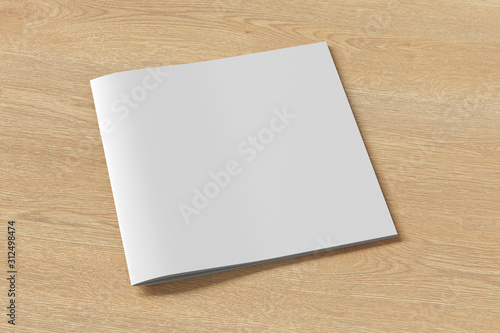 Square brochure or booklet cover mock up on wooden background. Isolated with clipping path around brochure. Side view. 3d illustratuion photo