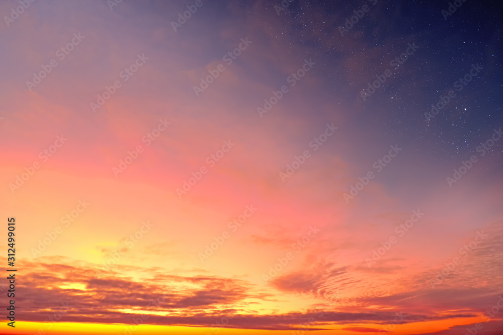 Orange sky at sunset and red clouds landscape against bright star on black universe background. Wide panorama view of stars in space nature at dark time. Starry night at night wallpaper