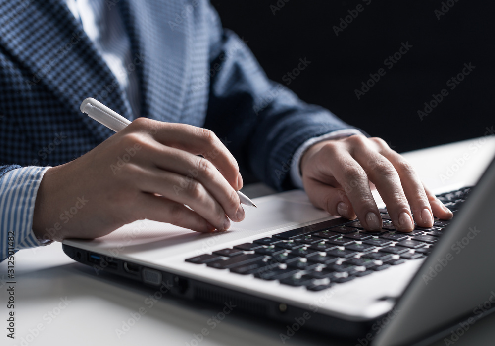 Man in business suit sitting at desk with laptop Man in business suit sitting at desk with laptop