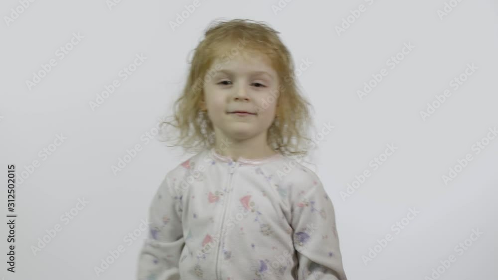 Little girl in pajama with funny headdress. Waving her hands. Greetings Little girl in pajama with funny headdress. Waving her hands. Greetings