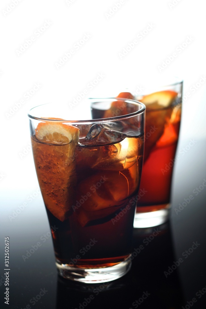 Close-up of cola with ice and lemon Close-up of cola with ice and lemon