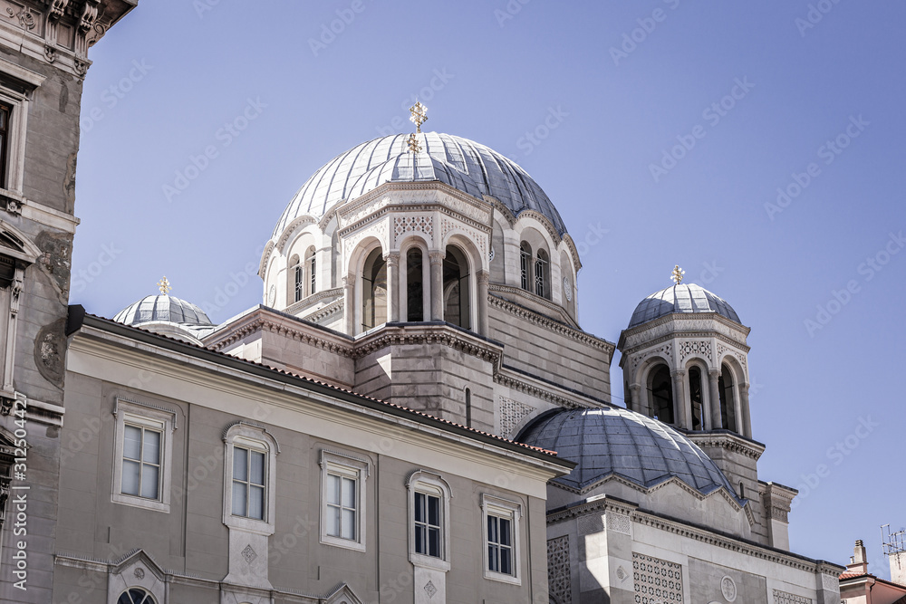 Serbian orthodox Saint spyridon church (Chiesa di San Spiridione) in Trieste, Italy near the canal grande on the square saint antonio nuovo with the white domes and details of the cathedral. Serbian orthodox Saint spyridon church (Chiesa di San Spiridione) in Trieste, Italy near the canal grande on the square saint antonio nuovo with the white domes and details of the cathedral.