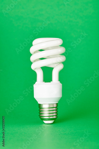 Energy saving lightbulb isolated on color background. Close up.