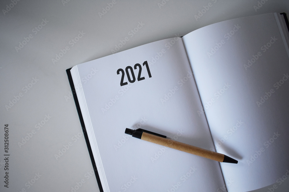 Calendar 2021 and pen on white background Calendar 2021 and pen on white background