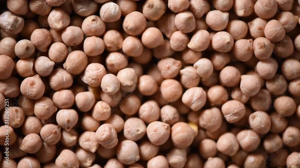 Raw organic dried chickpea texture on rotating background. Vegan healthy nutrition. Top view, copy space, healthy lifestyle concept. Raw organic dried chickpea texture on rotating background. Vegan healthy nutrition. Top view, copy space, healthy lifestyle concept.