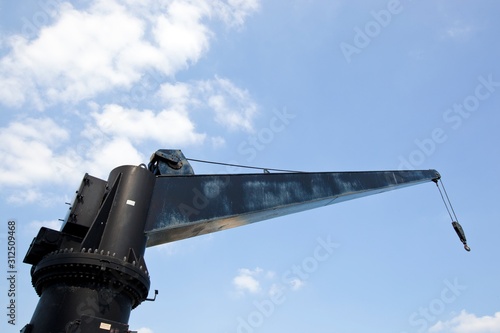 Black construction crane from below