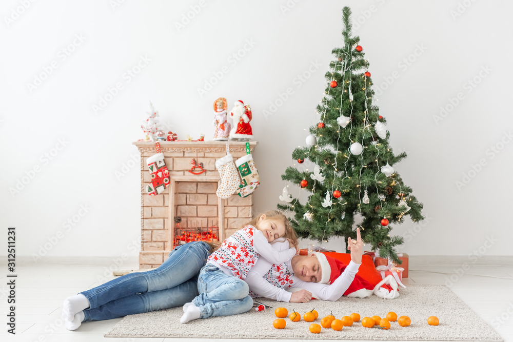 Holidays concept - happy family father and child at christmas tree at home